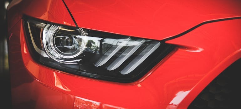 A headlight of a red car