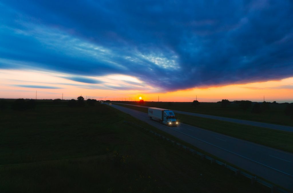 Cross country moving truck driving on a highway during a long-distance move.