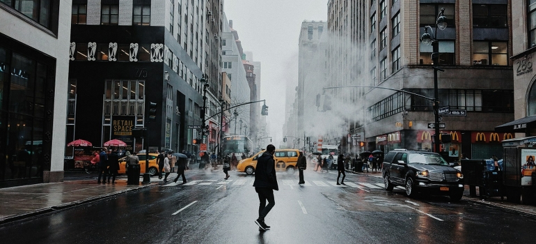 A man is walking down the streets of New York. 