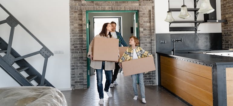 family unpacking after long distance move organized by broker