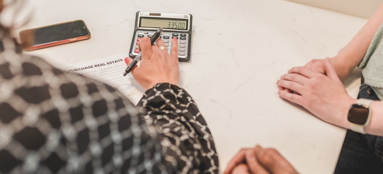 A person is using a calculator. 