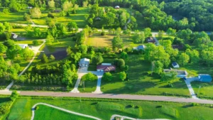 A aerial view of a rural homestead where a family has settled after moving from an urban area.
