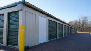 A self-storage temporary storage units with green doors.